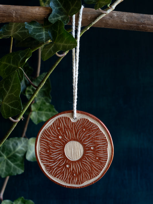 Woodcut ornament: Sun